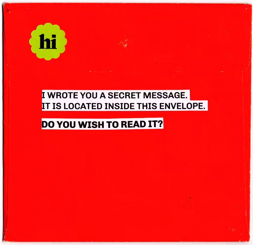 Back of red envelope with bolded text reading: I WROTE YOU A SECRET MESSAGE. IT IS LOCATED INSIDE THIS ENVELOPE. DO YOU WISH TO READ IT?
